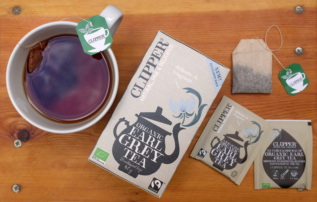 Collection of Clipper Earl Grey branding and tea bags.