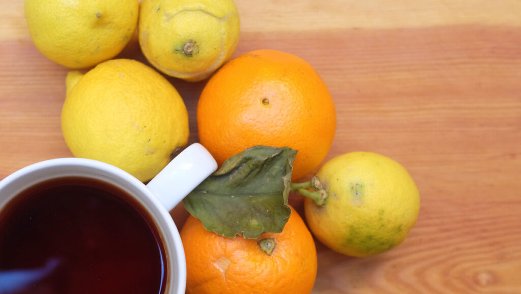 Cup of Earl Grey tea with orange and lemon.